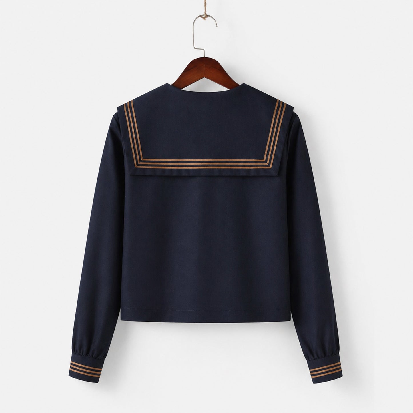 Uniforme escolar marinero con cuello ancho azul marino, tres líneas marrones y solapa cuadrada, corbata y lazo