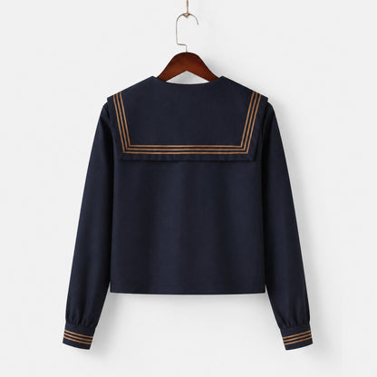 Uniforme escolar marinero con cuello ancho azul marino, tres líneas marrones y solapa cuadrada, corbata y lazo